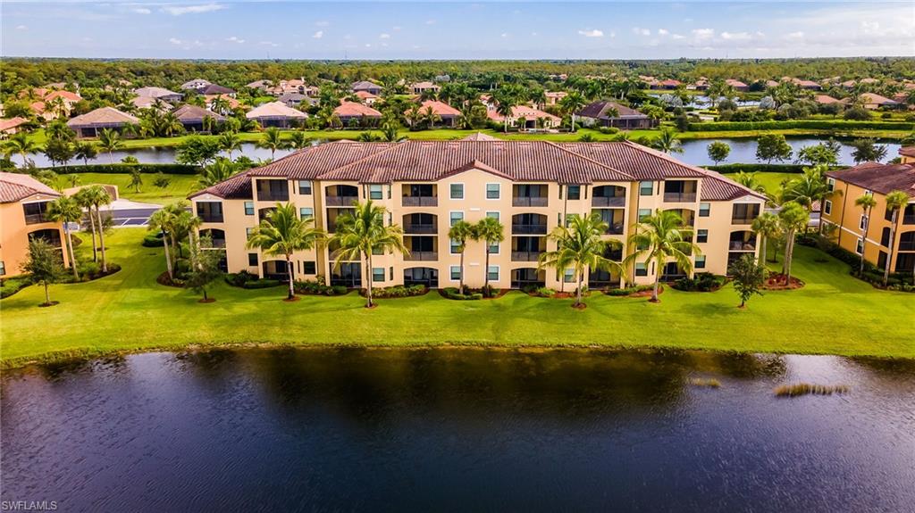 9727 Acqua Court, Unit 421 Naples, FL 34113 - Photo 29 of 35 a front view of a house with a garden