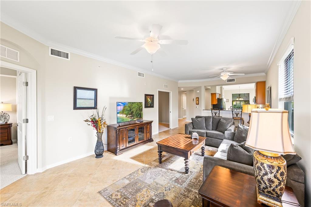 9727 Acqua Court, Unit 421 Naples, FL 34113 - Photo 3 of 35 a living room with furniture and a flat screen tv