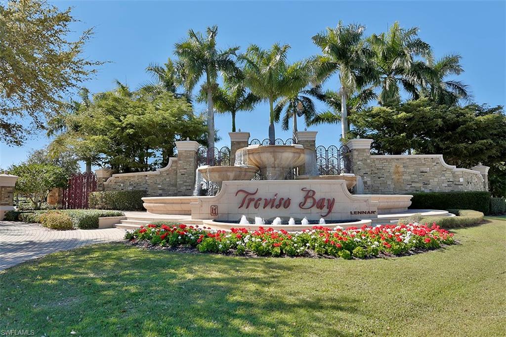9727 Acqua Court, Unit 421 Naples, FL 34113 - Photo 31 of 35 a garden with flowers and trees