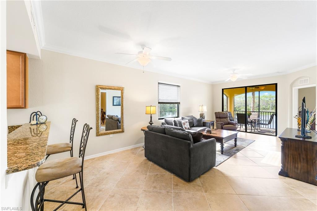 9727 Acqua Court, Unit 421 Naples, FL 34113 - Photo 4 of 35 a living room with furniture potted plant and a window