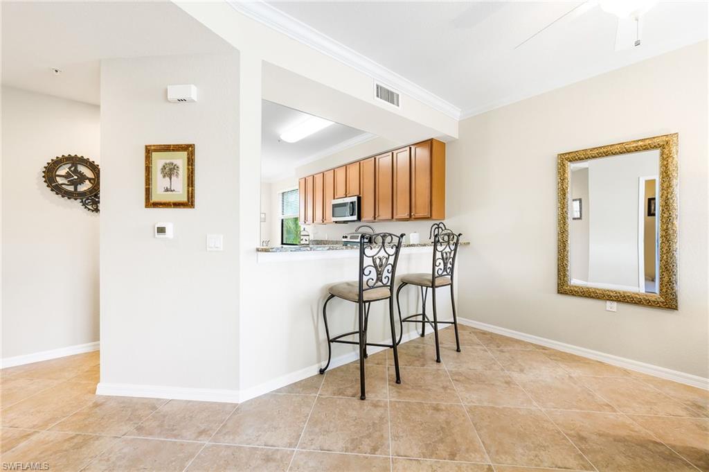 9727 Acqua Court, Unit 421 Naples, FL 34113 - Photo 7 of 35 a view of a livingroom with furniture and a window