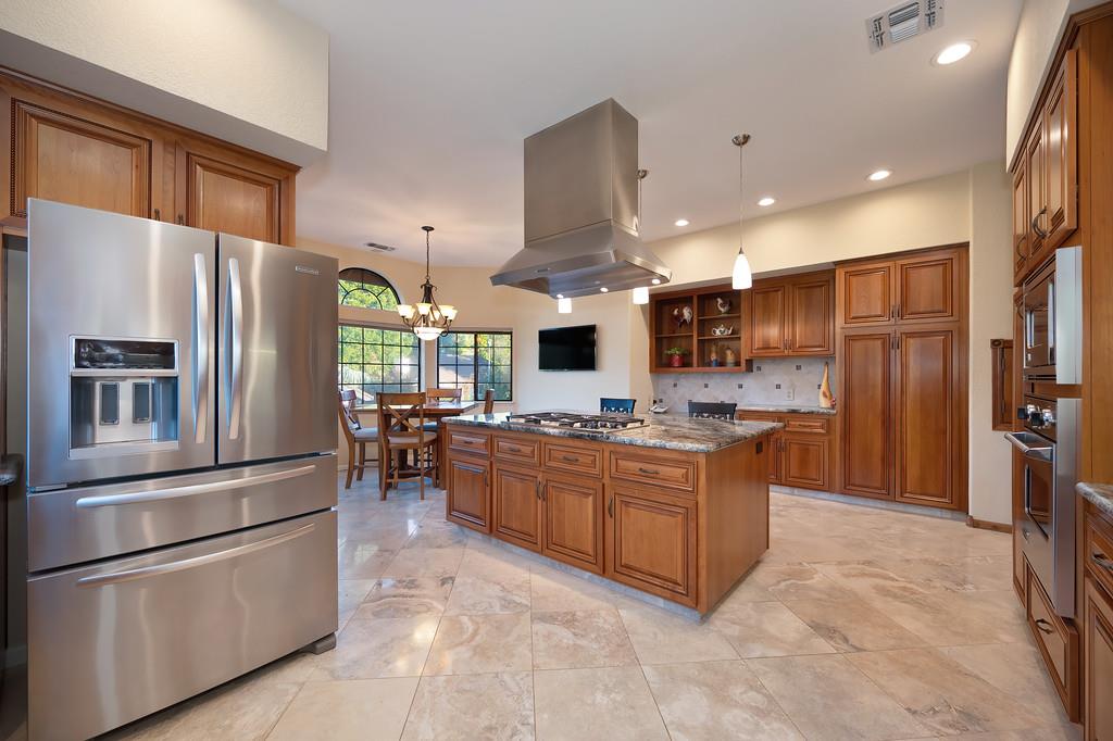 14965 Anillo Way Rancho Murieta, CA 95683 - Photo 15 of 59 a kitchen with stainless steel appliances granite countertop a refrigerator and a stove