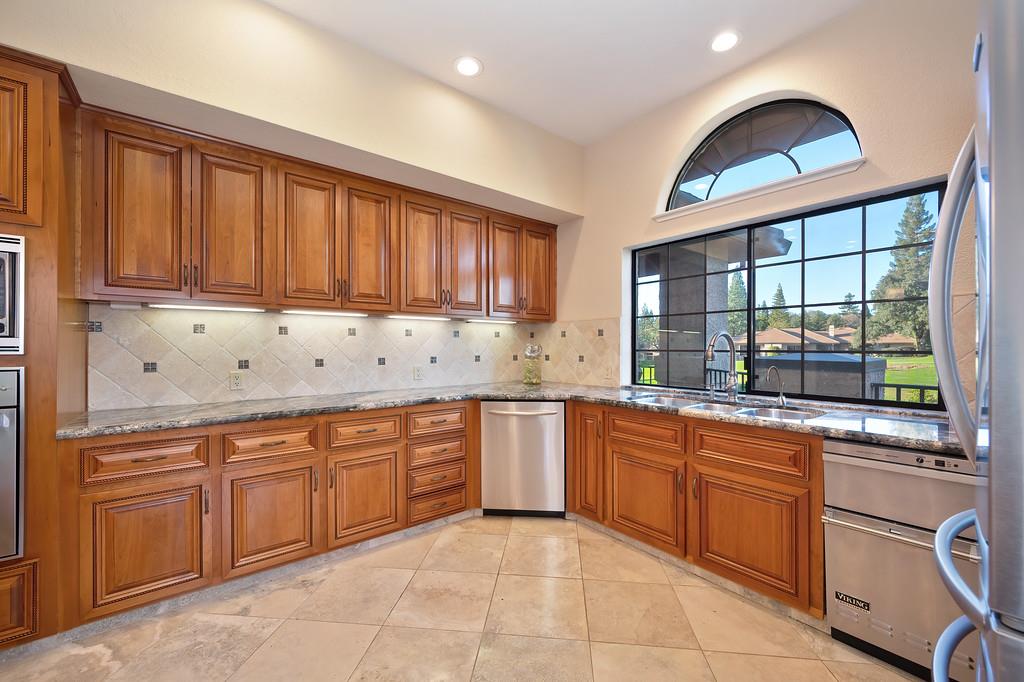 14965 Anillo Way Rancho Murieta, CA 95683 - Photo 16 of 59 a kitchen with stainless steel appliances granite countertop a stove sink and cabinets