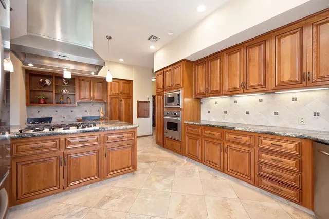 a living room with furniture a ceiling fan a rug and a window