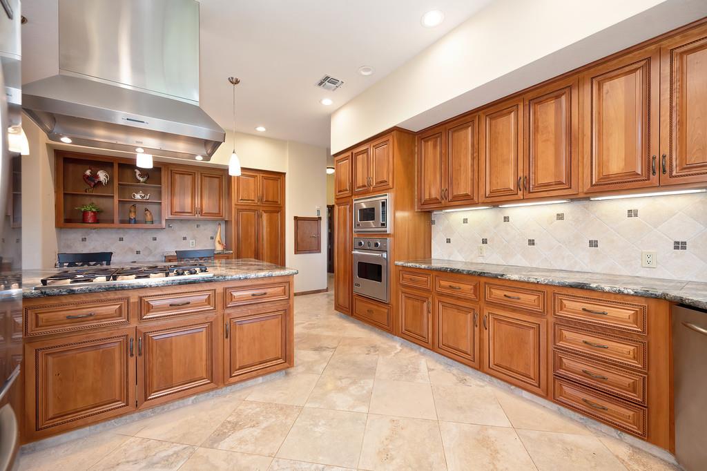 14965 Anillo Way Rancho Murieta, CA 95683 - Photo 17 of 59 a kitchen with stainless steel appliances granite countertop a stove sink and cabinets
