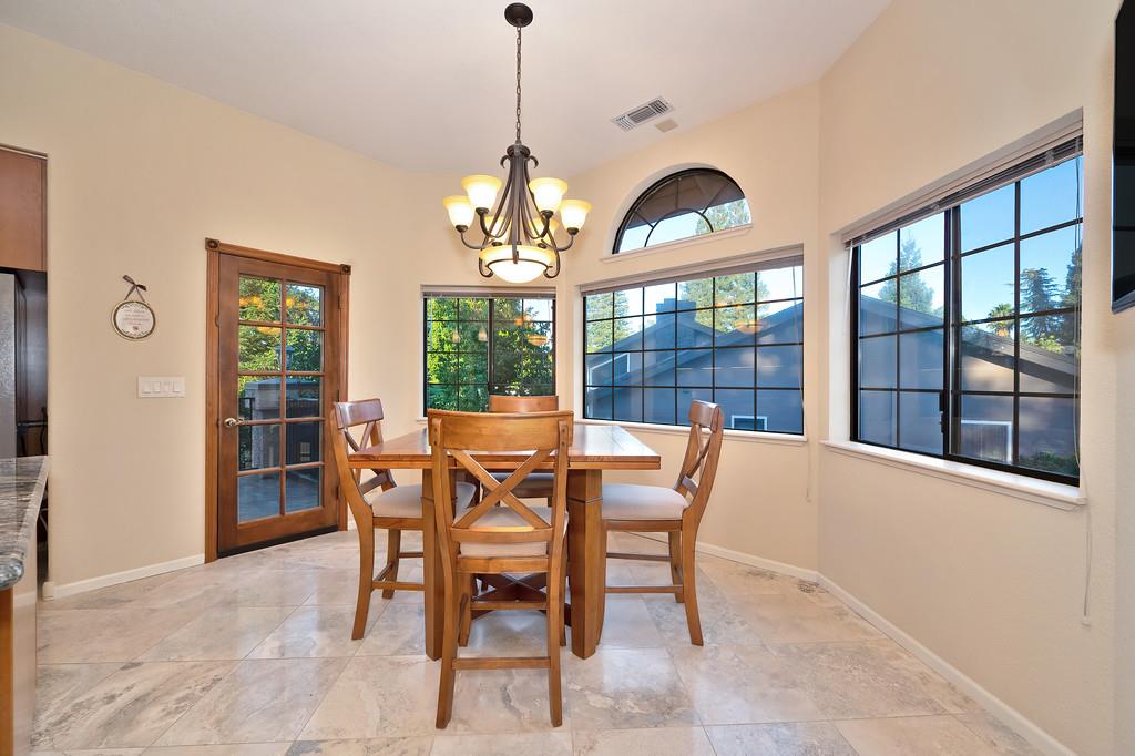 14965 Anillo Way Rancho Murieta, CA 95683 - Photo 18 of 59 a dining room with furniture large windows and a chandelier