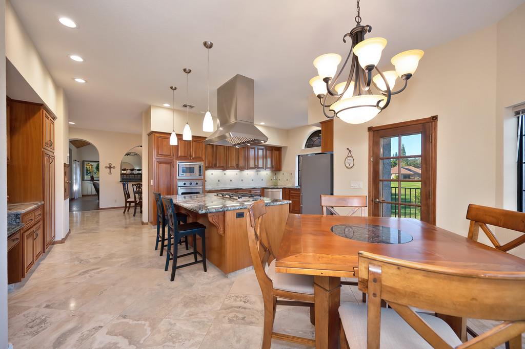 14965 Anillo Way Rancho Murieta, CA 95683 - Photo 19 of 59 a view of a dining room with furniture a chandelier and wooden floor