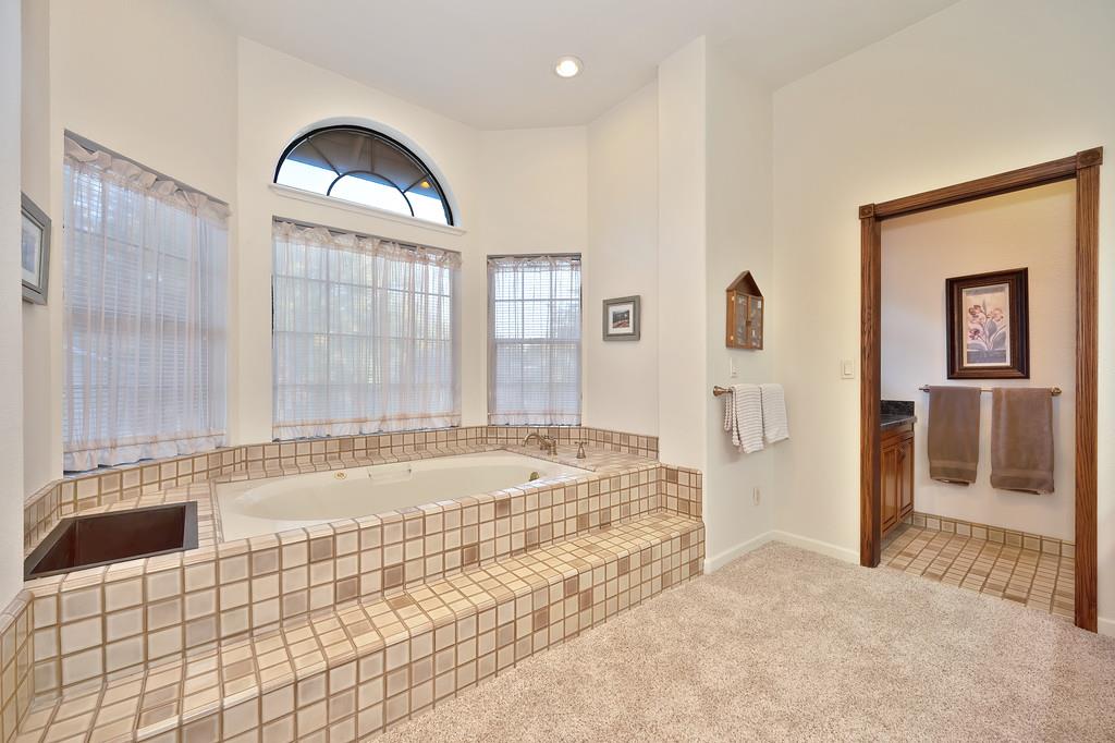 14965 Anillo Way Rancho Murieta, CA 95683 - Photo 27 of 59 a spacious bedroom with a bed and a painting on the wall