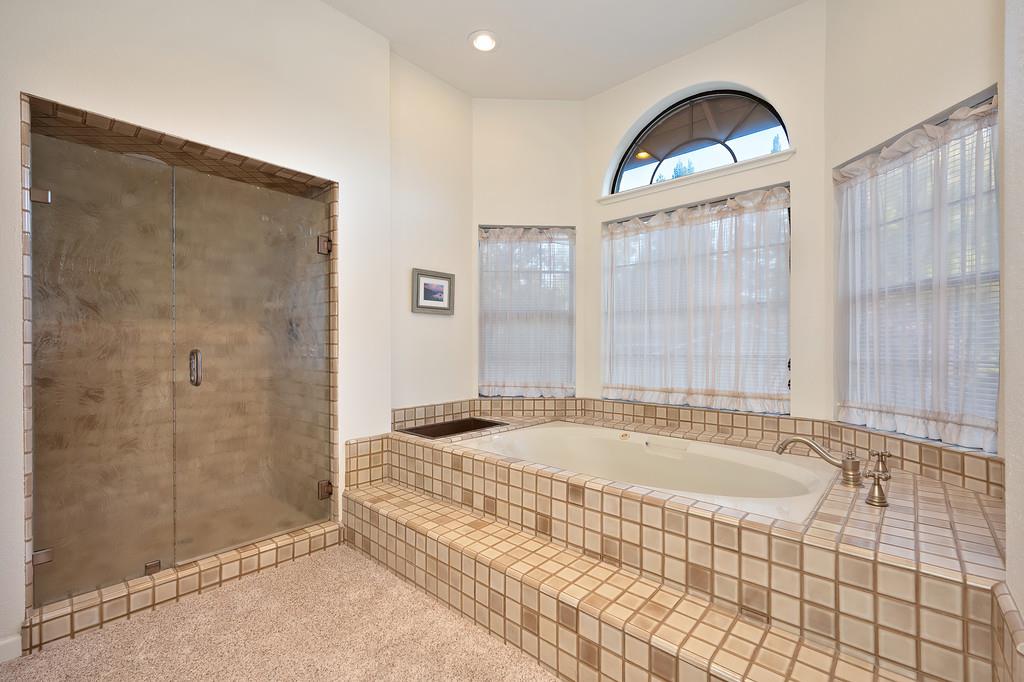 14965 Anillo Way Rancho Murieta, CA 95683 - Photo 28 of 59 a bathroom with a tub a sink and a shower