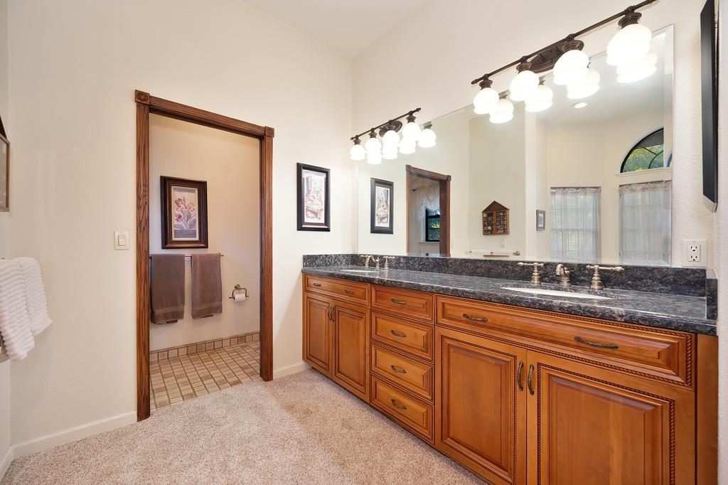14965 Anillo Way Rancho Murieta, CA 95683 - Photo 30 of 59 a spacious bathroom with a granite countertop sink mirror and a