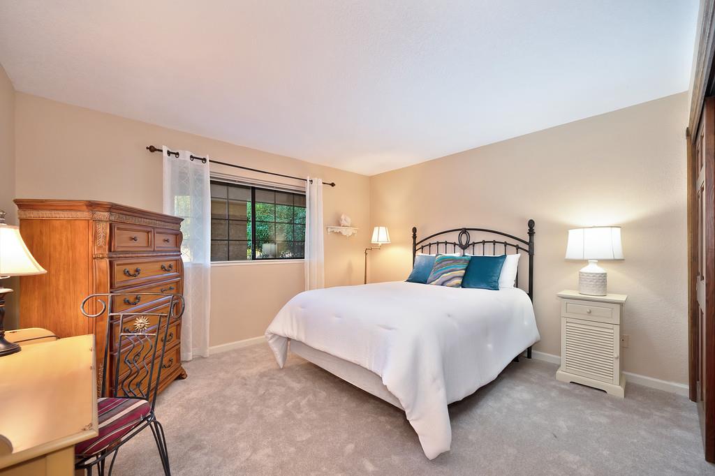 14965 Anillo Way Rancho Murieta, CA 95683 - Photo 31 of 59 a bedroom with a bed next to a window with lamp