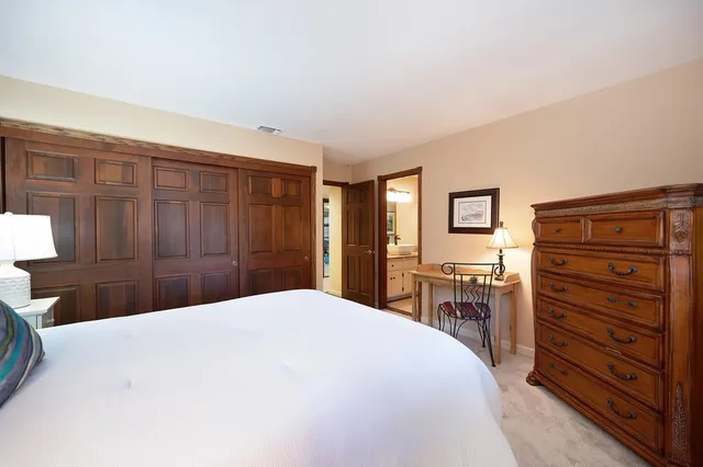 a bedroom with furniture a window and a wooden floor