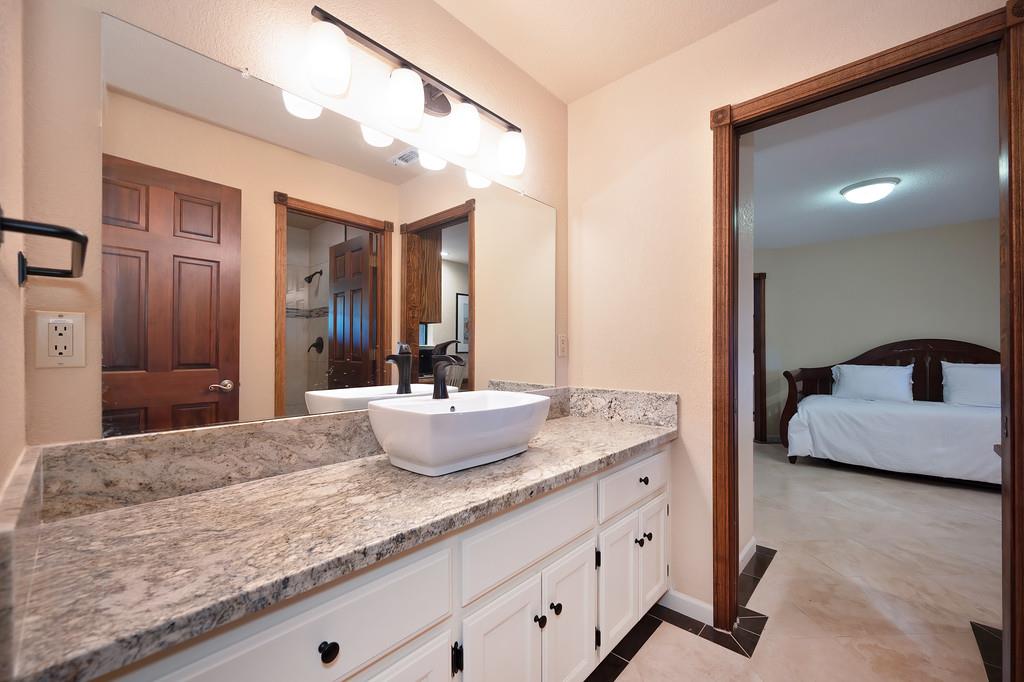 14965 Anillo Way Rancho Murieta, CA 95683 - Photo 35 of 59 a bathroom with a granite countertop sink and a mirror