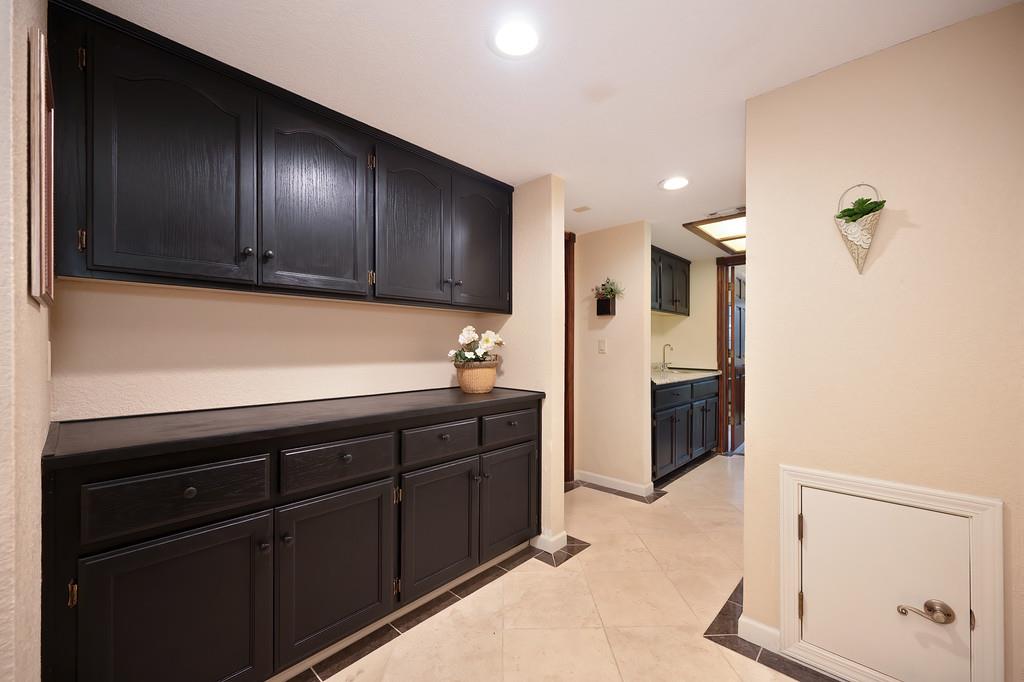 14965 Anillo Way Rancho Murieta, CA 95683 - Photo 38 of 59 a kitchen with granite countertop stainless steel appliances and wooden cabinets