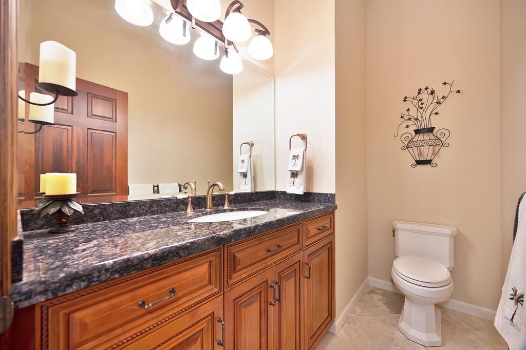 14965 Anillo Way Rancho Murieta, CA 95683 - Photo 41 of 59 a bathroom with a granite countertop sink a toilet and mirror