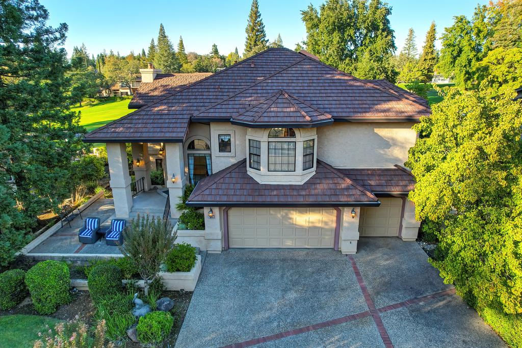 14965 Anillo Way Rancho Murieta, CA 95683 - Photo 57 of 59 a front view of a house with a yard and garage