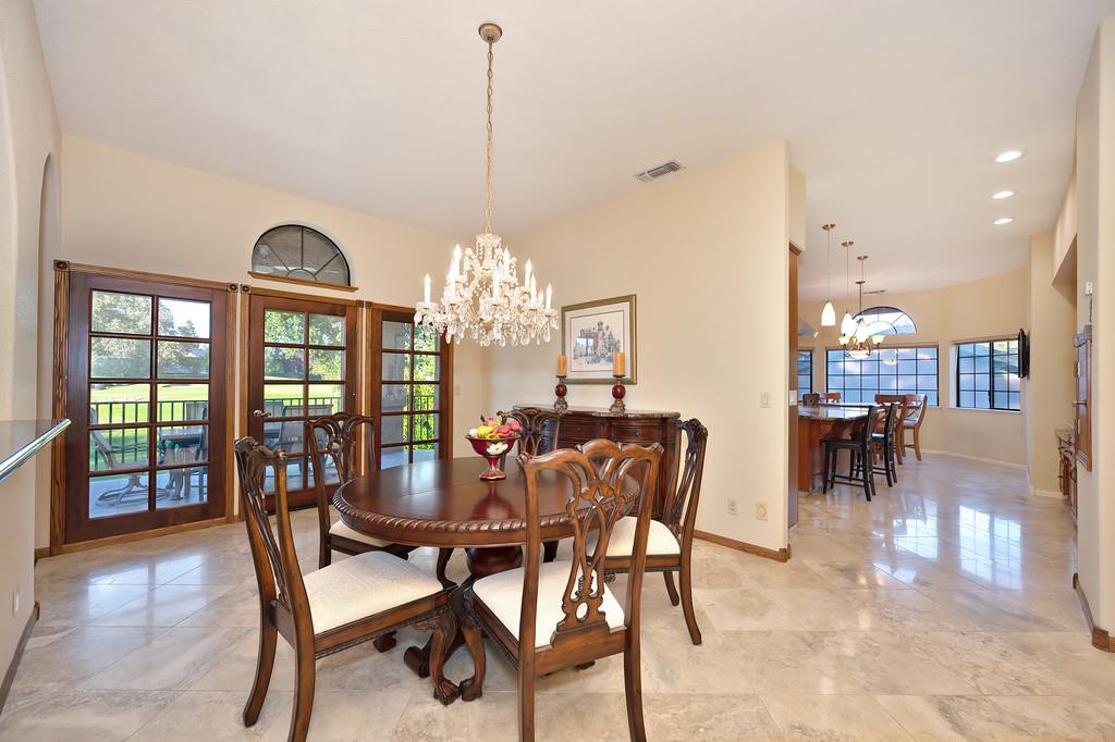 14965 Anillo Way Rancho Murieta, CA 95683 - Photo 9 of 59 a view of a dining room with furniture a chandelier and wooden floor