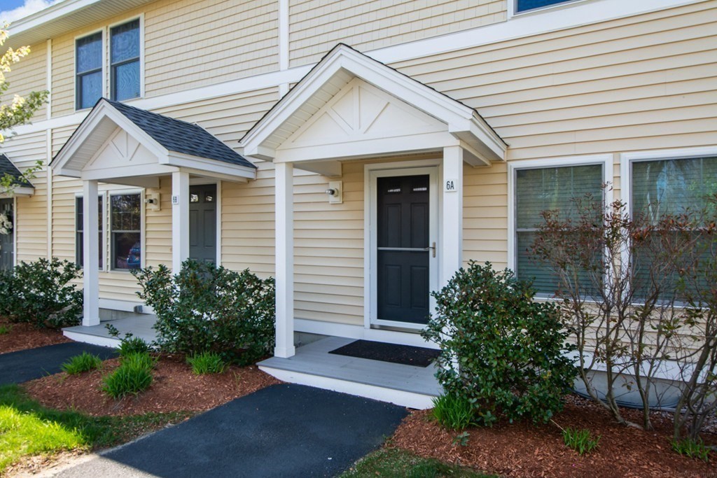 6 Bates Street, Unit A Devens, MA 01434 - Photo 3 of 41 a view of a white house next to a yard