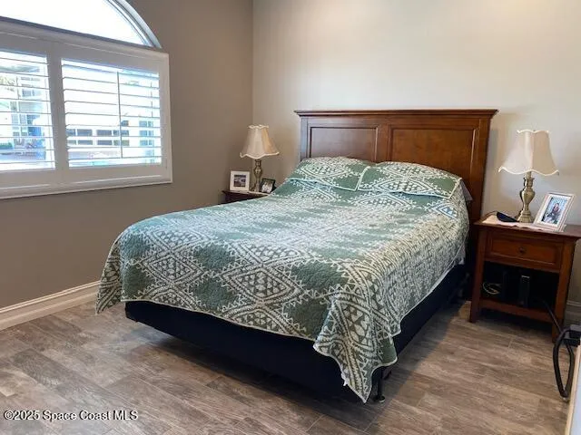 a bedroom with a bed and flat screen tv