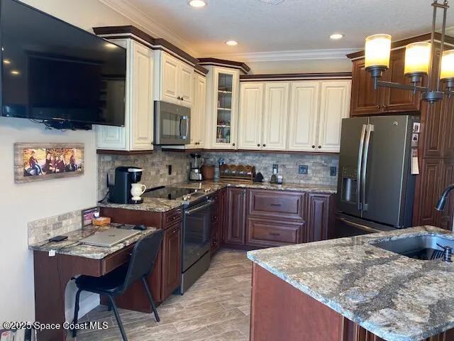 a kitchen with stainless steel appliances granite countertop a refrigerator