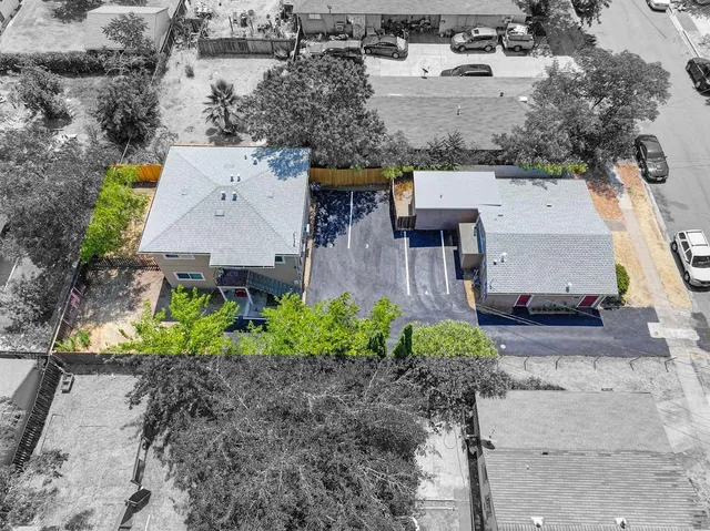 an aerial view of a house with a yard and lake view