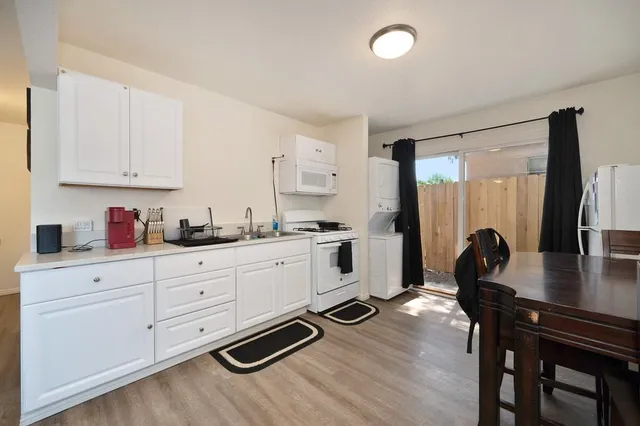 a kitchen with sink refrigerator and cabinets