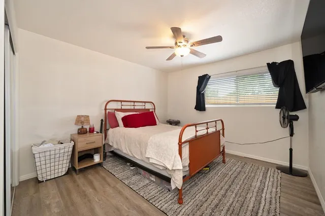 a bedroom with a bed and wooden floor