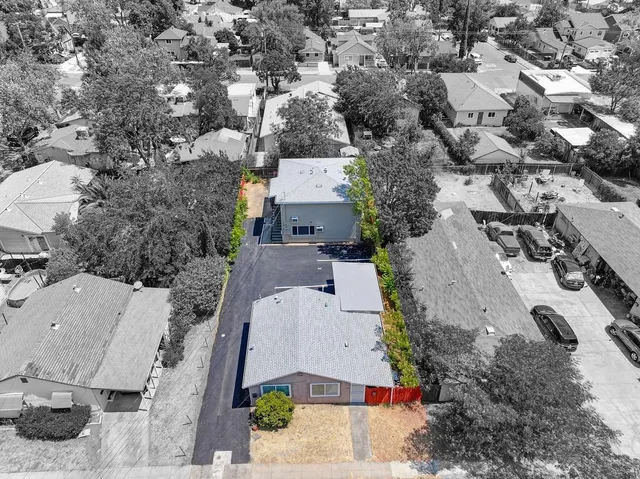 an aerial view of residential houses with outdoor space