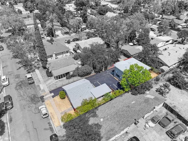 an aerial view of a house with a yard