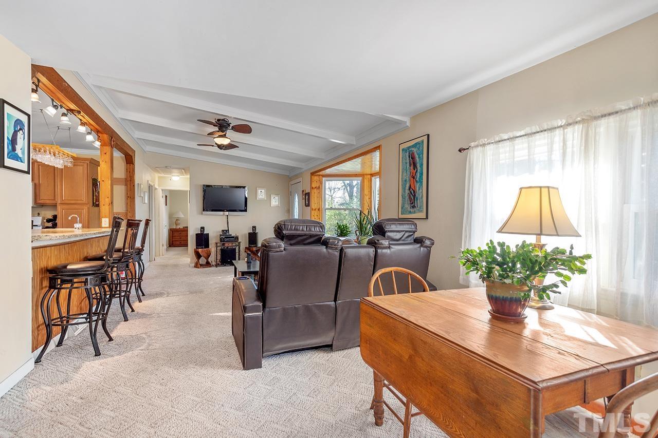 2820 Willow Court Raleigh, NC 27610 - Photo 11 of 33 a living room with furniture a chandelier and a dining table