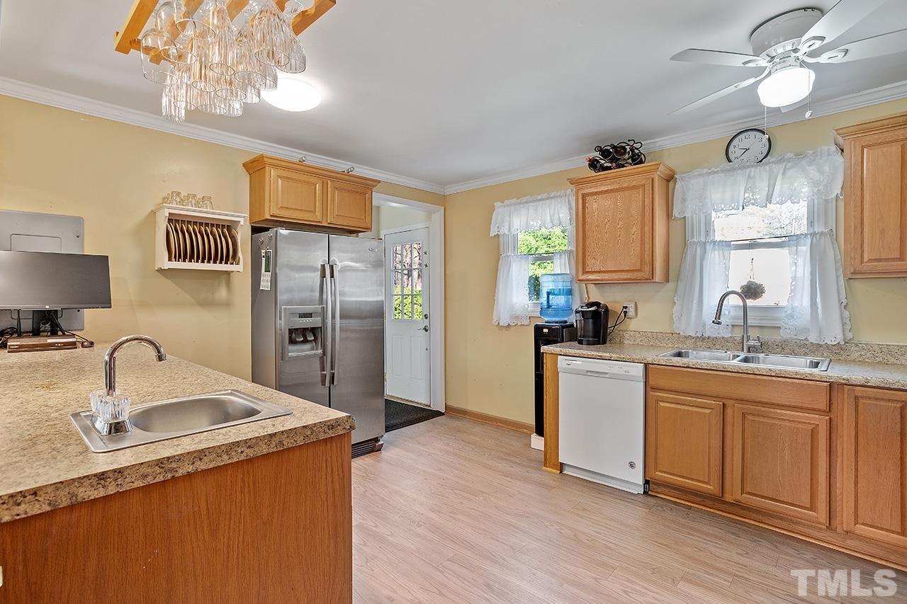 2820 Willow Court Raleigh, NC 27610 - Photo 12 of 33 a kitchen with stainless steel appliances granite countertop a sink stove and refrigerator