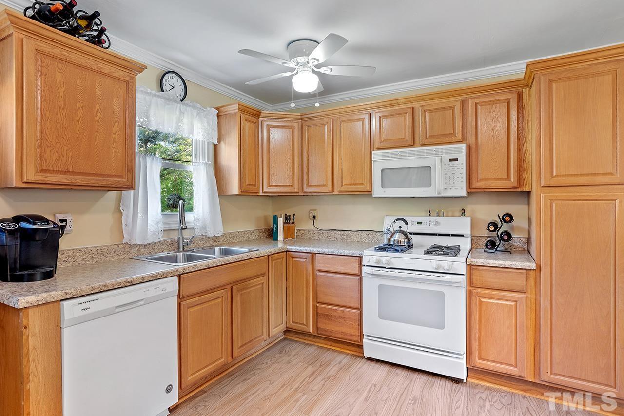 2820 Willow Court Raleigh, NC 27610 - Photo 13 of 33 a kitchen with a stove a sink and a refrigerator
