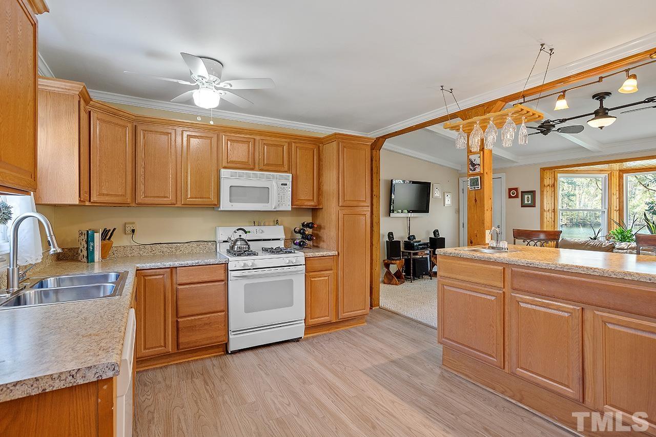 2820 Willow Court Raleigh, NC 27610 - Photo 14 of 33 a kitchen with stainless steel appliances granite countertop a sink and cabinets