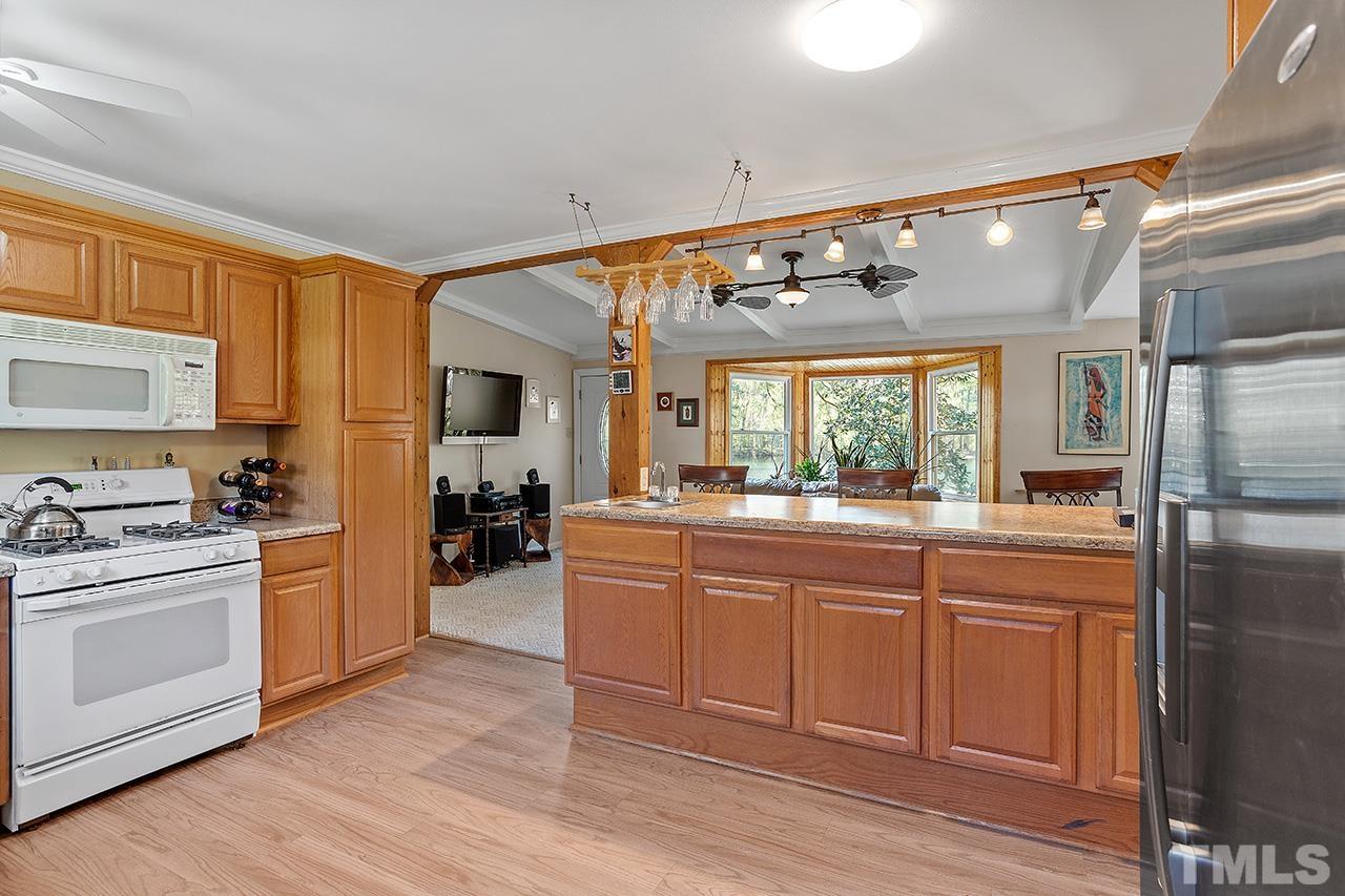 2820 Willow Court Raleigh, NC 27610 - Photo 15 of 33 a large kitchen with cabinets a sink and appliances