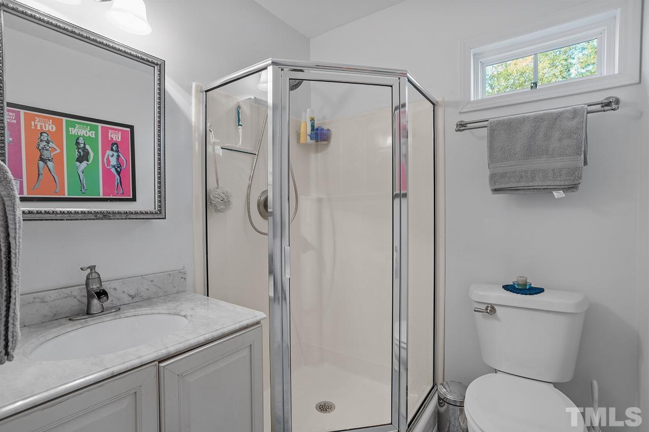 2820 Willow Court Raleigh, NC 27610 - Photo 17 of 33 a bathroom with a granite countertop sink toilet and shower