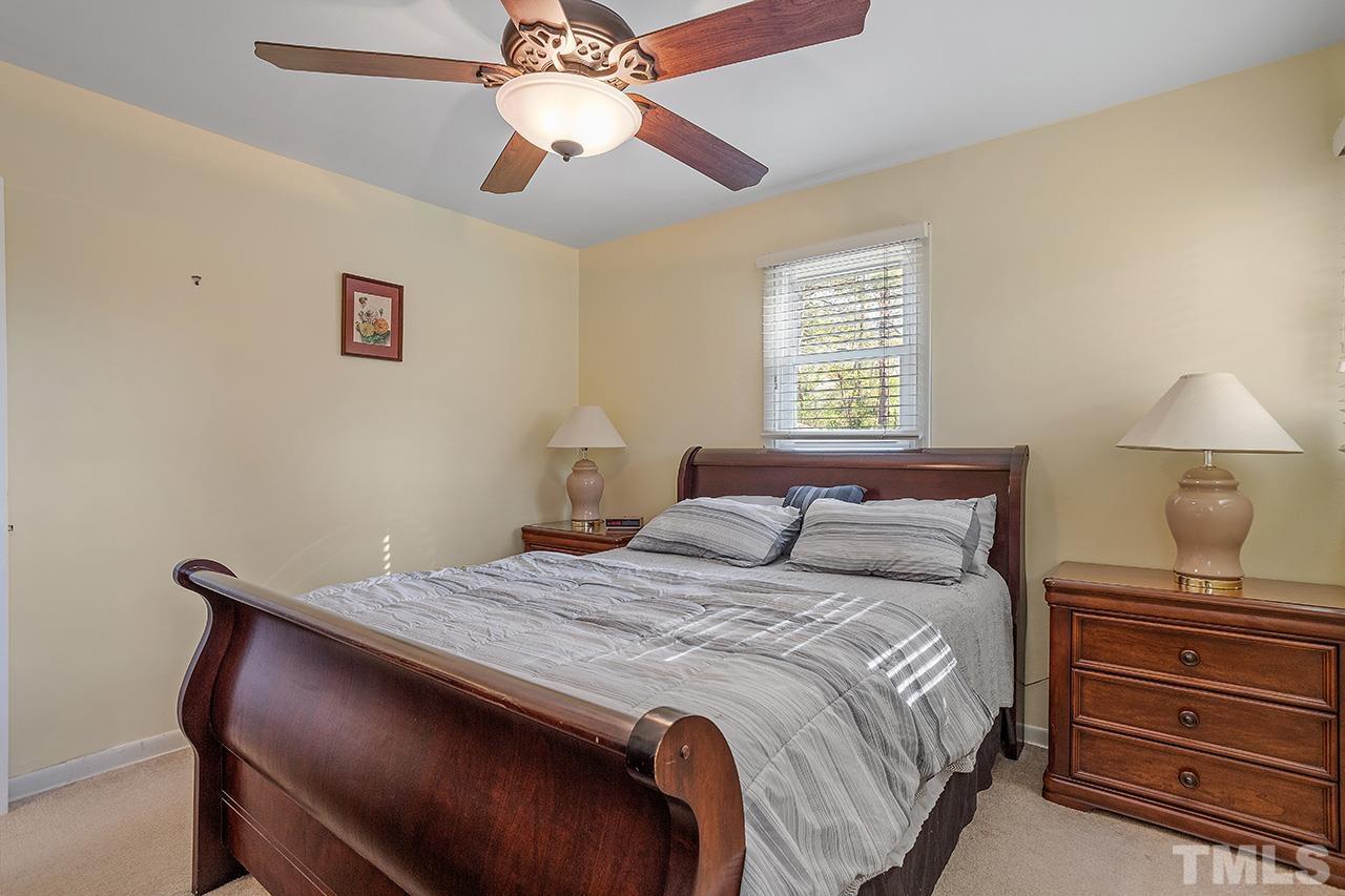 2820 Willow Court Raleigh, NC 27610 - Photo 20 of 33 a bedroom with a bed and a chandelier