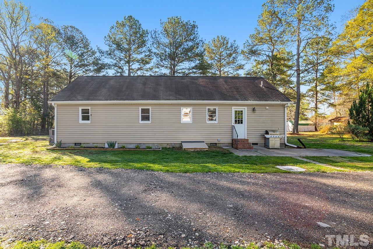 2820 Willow Court Raleigh, NC 27610 - Photo 28 of 33 a view of backyard of house with outdoor seating and trees