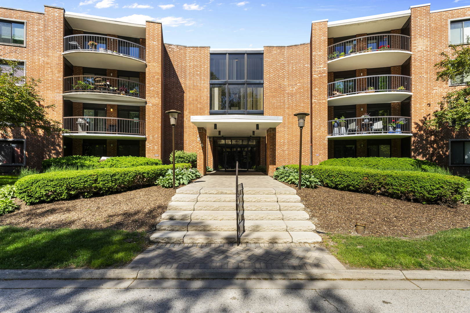 a front view of a building with a garden