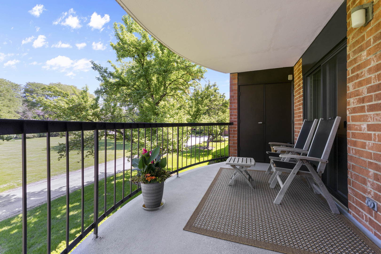1615 East Central Road, Unit 222C Arlington Heights, IL 60005 - Photo 12 of 30 a view of a balcony with chair and wooden floor