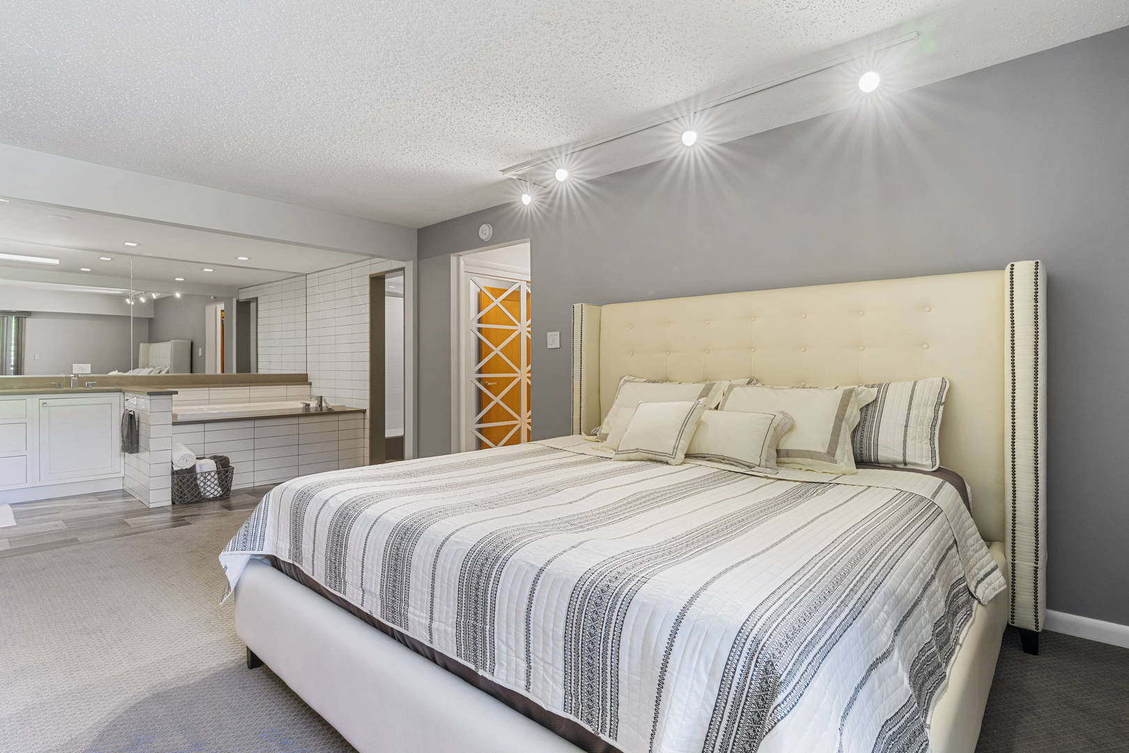 1615 East Central Road, Unit 222C Arlington Heights, IL 60005 - Photo 13 of 30 a bedroom with a bed and a large mirror