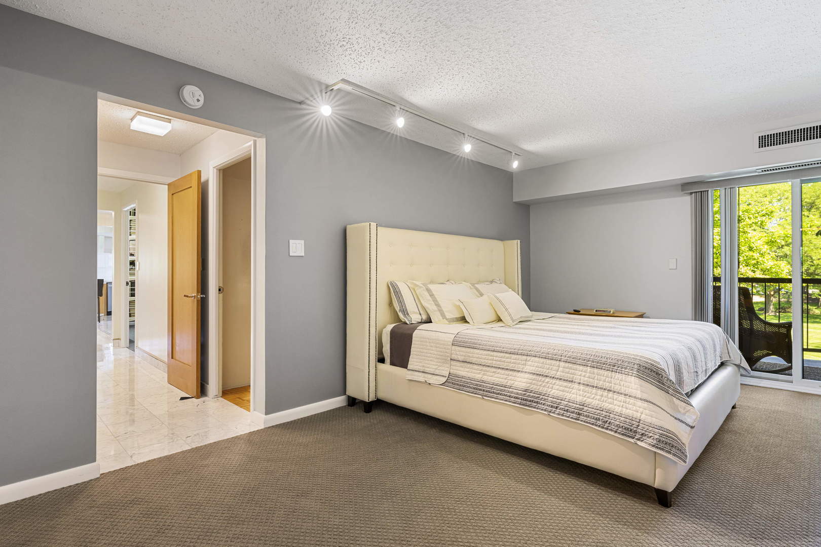 1615 East Central Road, Unit 222C Arlington Heights, IL 60005 - Photo 14 of 30 a spacious bedroom with a bed and a couch
