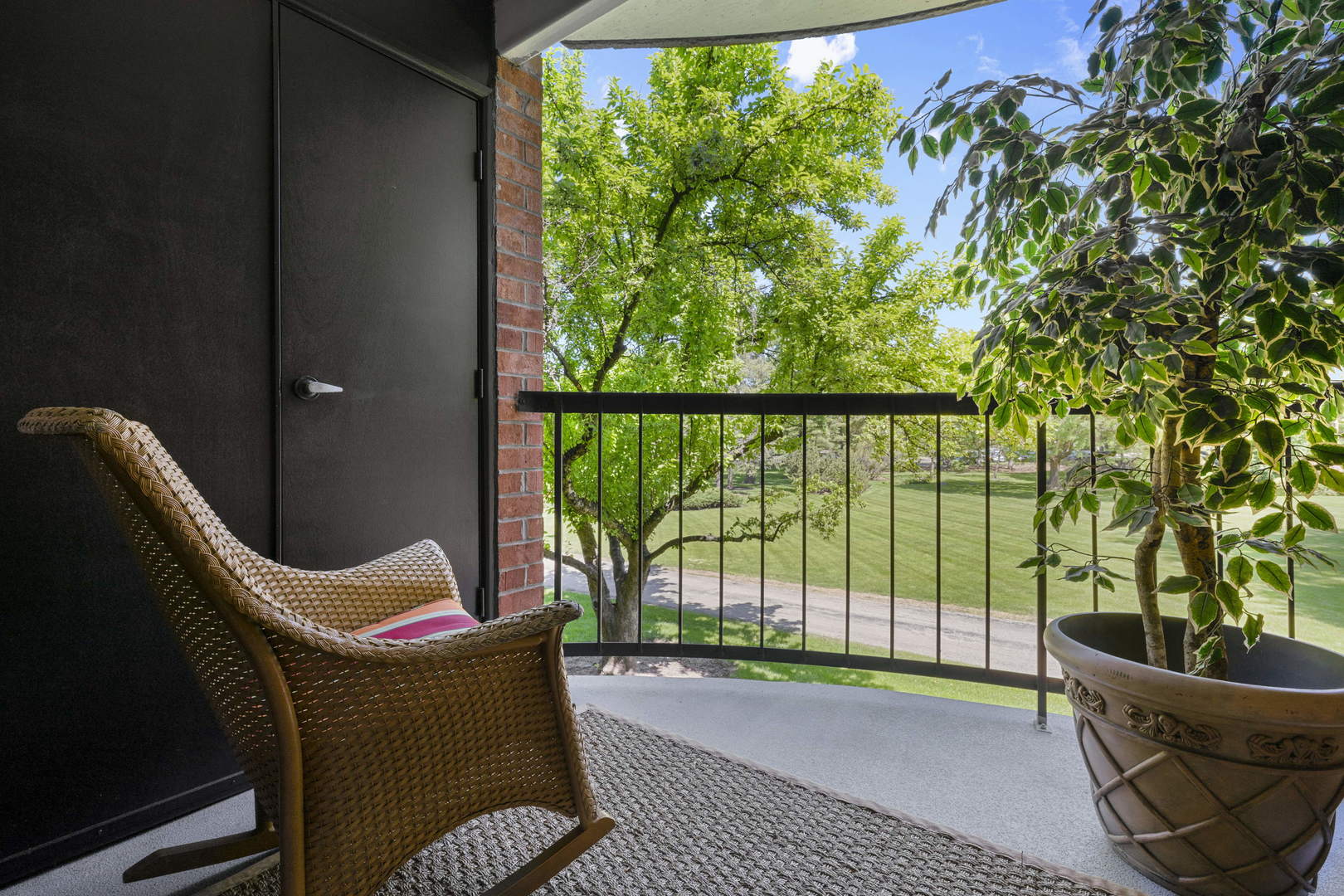 1615 East Central Road, Unit 222C Arlington Heights, IL 60005 - Photo 18 of 30 a balcony with table and chairs