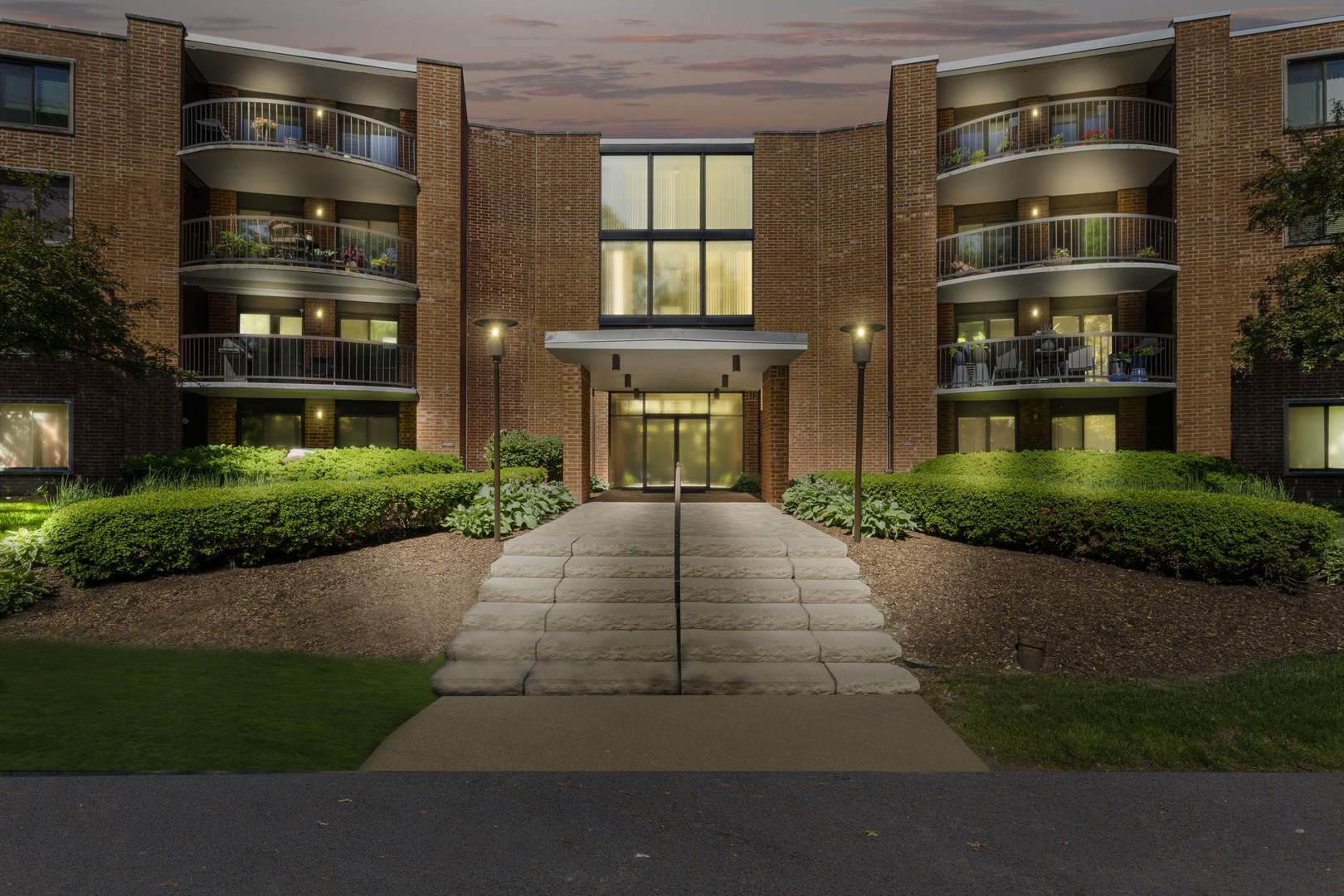 1615 East Central Road, Unit 222C Arlington Heights, IL 60005 - Photo 30 of 30 a front view of multi story residential apartment building with yard and parking