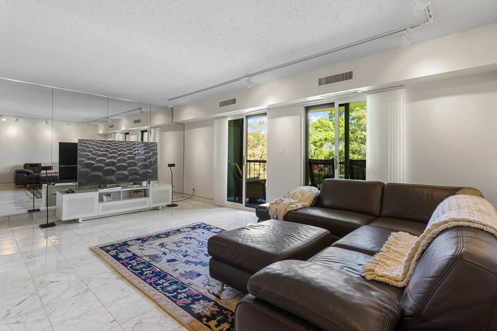 1615 East Central Road, Unit 222C Arlington Heights, IL 60005 - Photo 10 of 30 a living room with furniture and a flat screen tv
