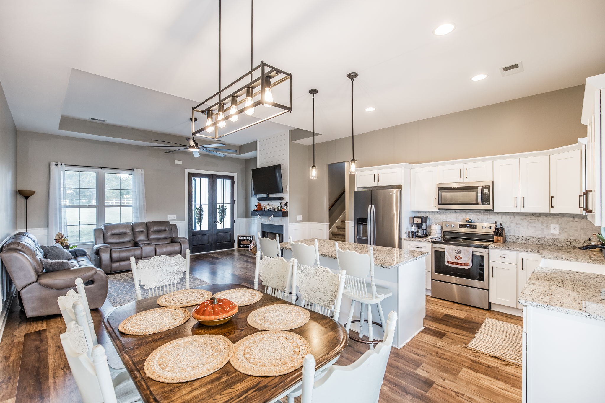 721 New Deal Potts Road Cottontown, TN 37048 - Photo 20 of 73 a kitchen with stainless steel appliances kitchen island granite countertop a refrigerator a stove a sink a dining table and chairs with wooden floor