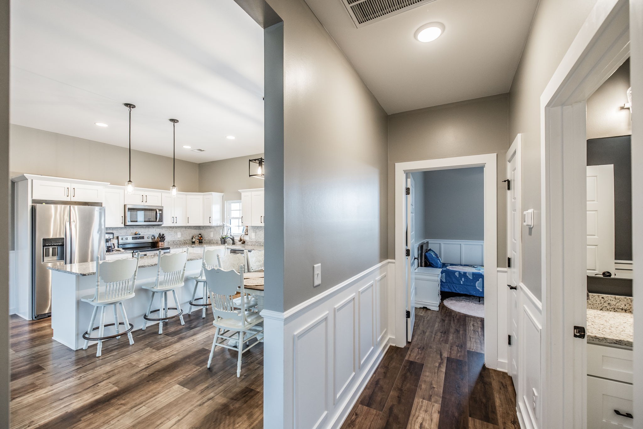 721 New Deal Potts Road Cottontown, TN 37048 - Photo 33 of 73 a view of a kitchen with kitchen island white cabinets and wooden floor