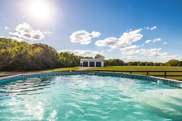 an aerial view of residential building with swimming pool