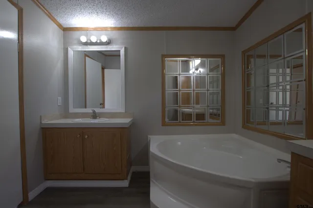 a bathroom with bathtub and window