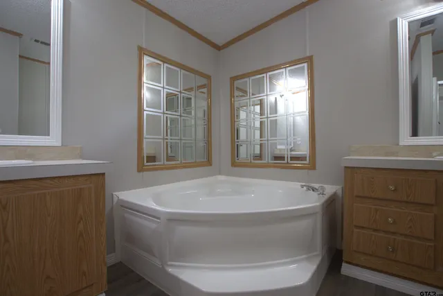 a bath tub sitting in a bathroom next to a window