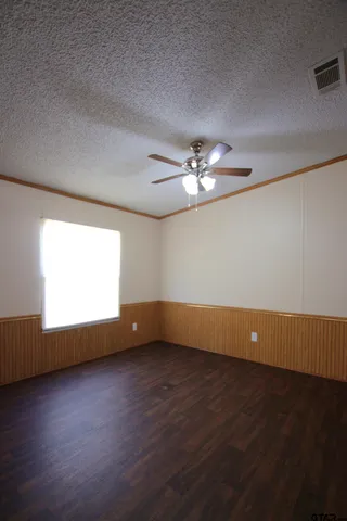 a view of room with window and wooden floor